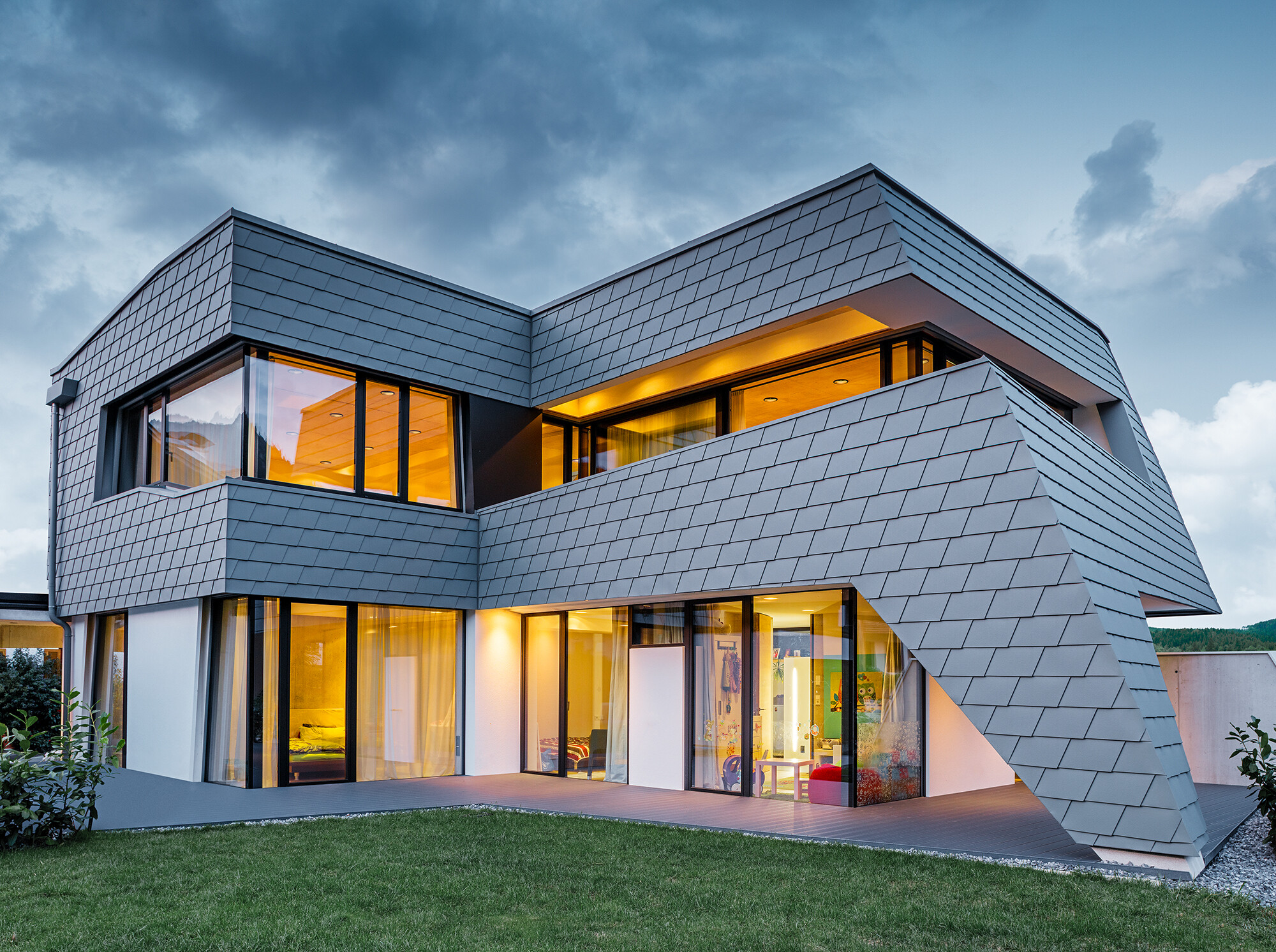 Obytný dom s fasádnymi šindľami PREFA vo farbe P.10 svetlošedá na fasáde