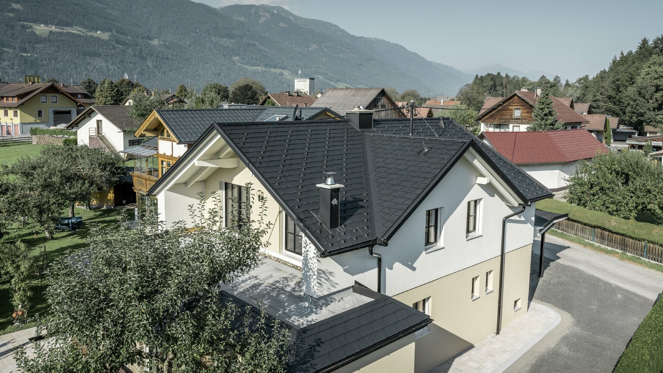 Tradičný rodinný dom so sedlovou strechou a veľkým vikierom, čerstvo zrekonštruovaný. Strecha je pokrytá čiernymi strešnými šindľami PREFA.