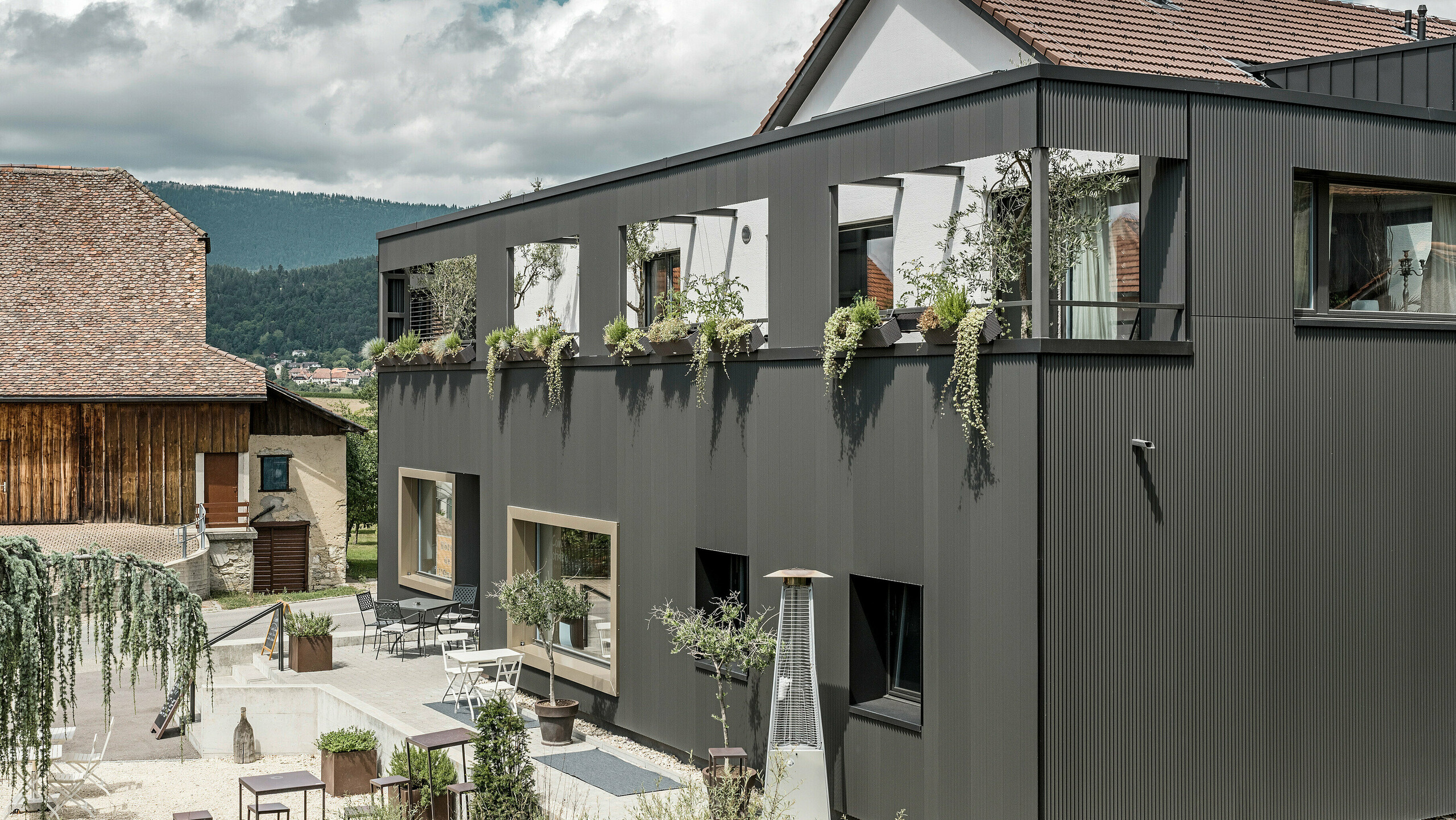 Prelamovaný profil PREFA v špeciálnej čiernošedej farbe v Hôtel de l'Ours v Prêles, Švajčiarsko